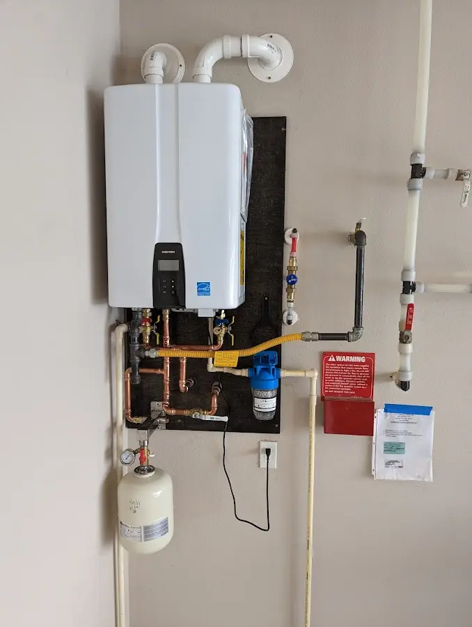 Professional plumber installing copper piping in a East Huntingdon home